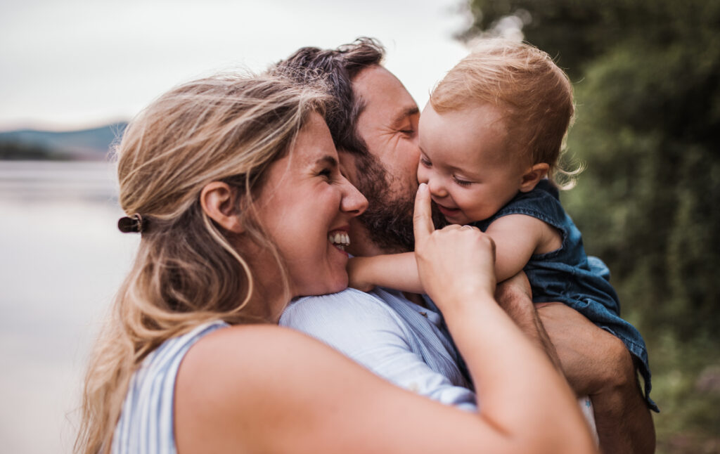 A couple holding a baby