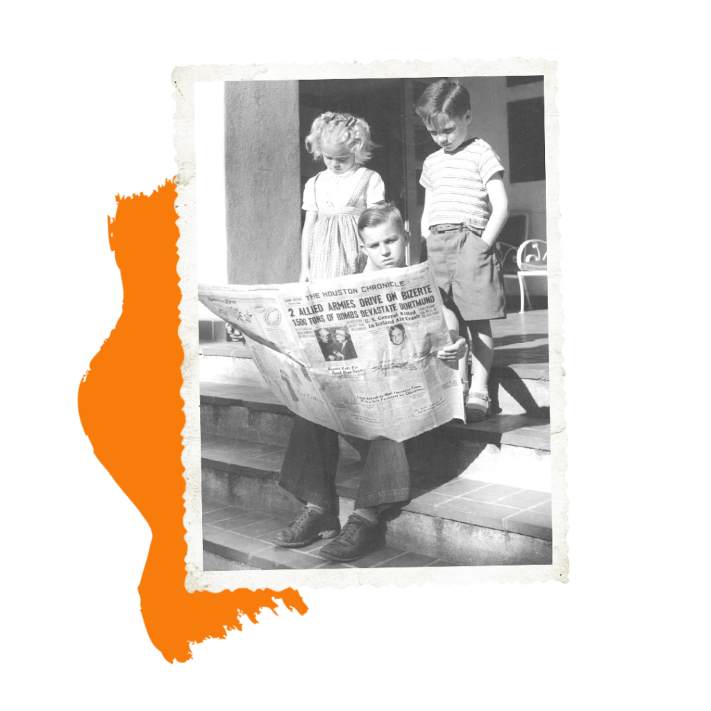 Three children sitting on the front steps. One child is reading a news paper.