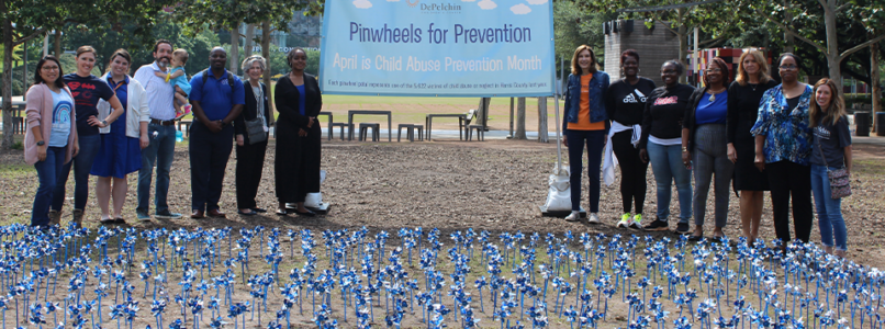 A group of people gathered at a Pinwheels for Prevention ceremony