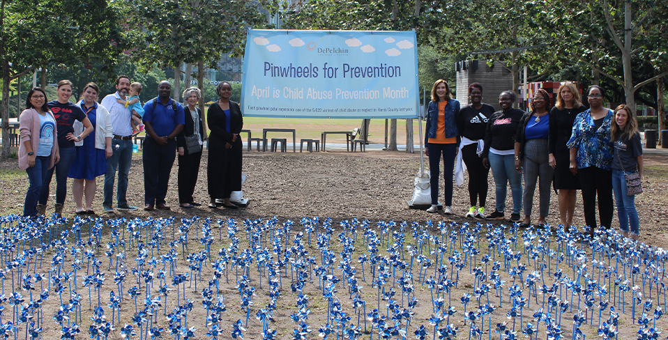 A group of people gathered at a Pinwheels for Prevention ceremony