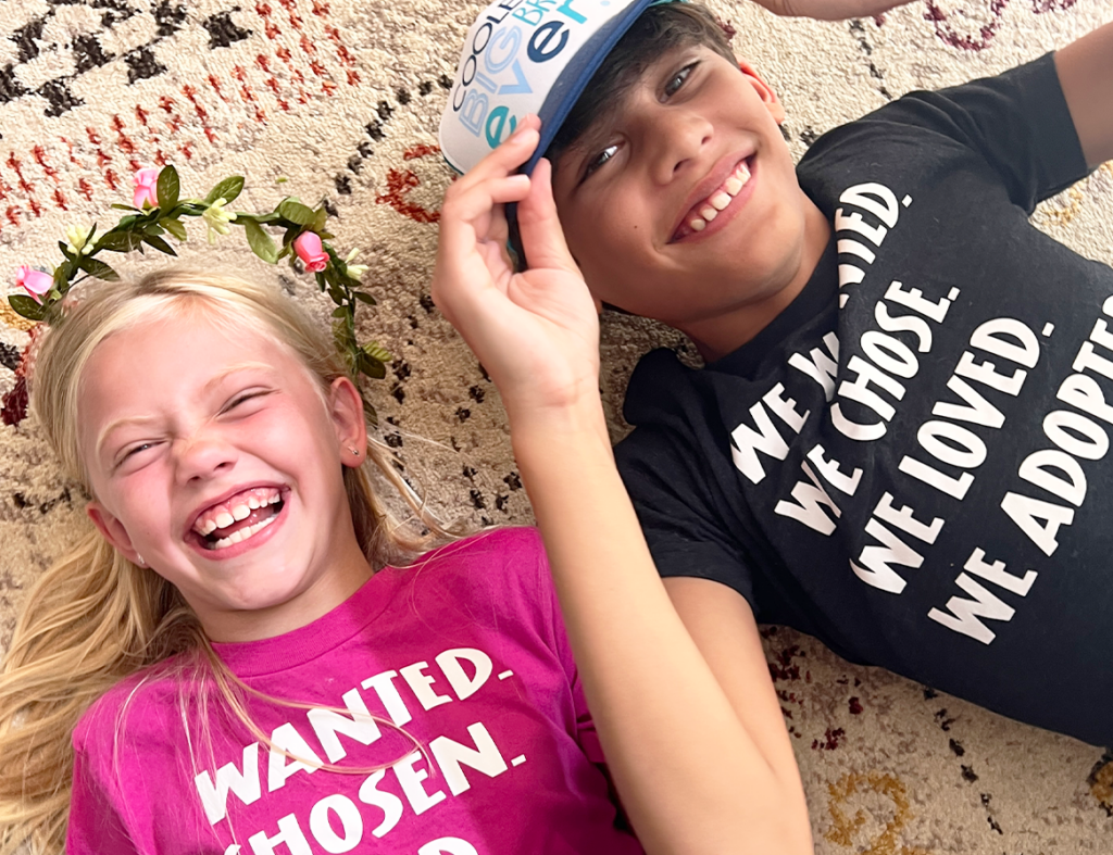 A boy and girl laying on the floor laughing