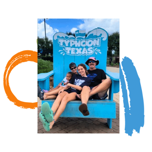 A family sitting in an oversized chair at Typhoon Texas