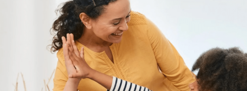 A child giving their mother a high five