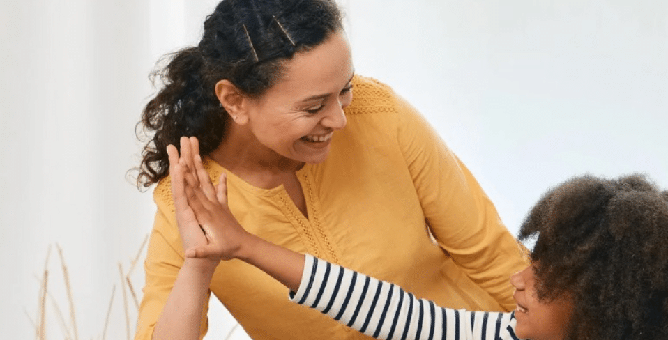 A child giving their mother a high five